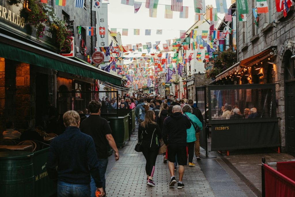 Street decorated with colorful international flags, cultural diversity celebration in Galway, Ireland